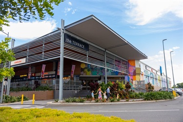 A young family walks past The Terrace dining precinct at Stockland Rockhampton shopping centre