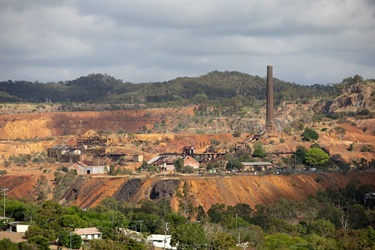 An aerial view of the historic Mount Morgan gold mine and its historic buildings and brick chimney