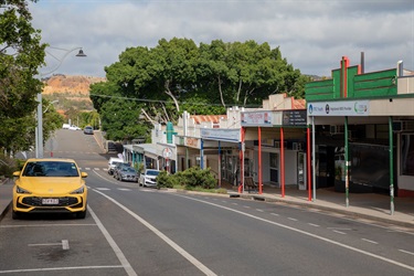 Historic buildings line the main street of Mount Morgan, with its historic gold mine visible in the distance
