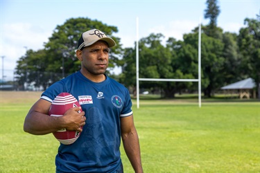 Portrait of a man holding a rugby league ball