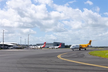Three planes are parked on the tarmac outside the Rockhampton Airport terminal