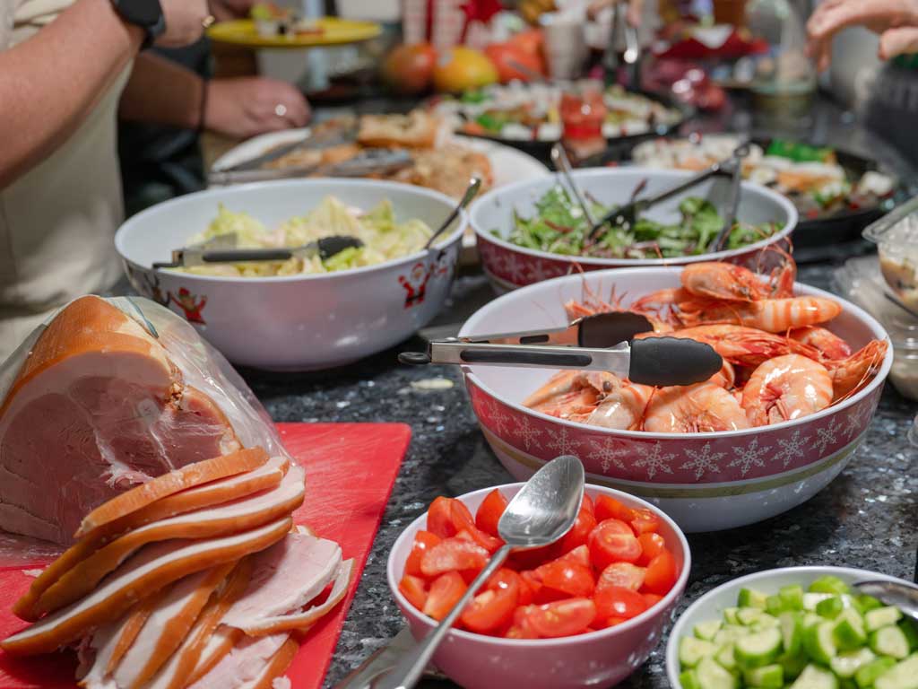 An Australian Christmas lunch is laid out on a table including ham, prawns and salads