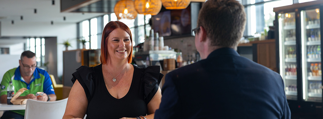 A man and woman sit in a cafe inside the Rockhampton Airport terminal