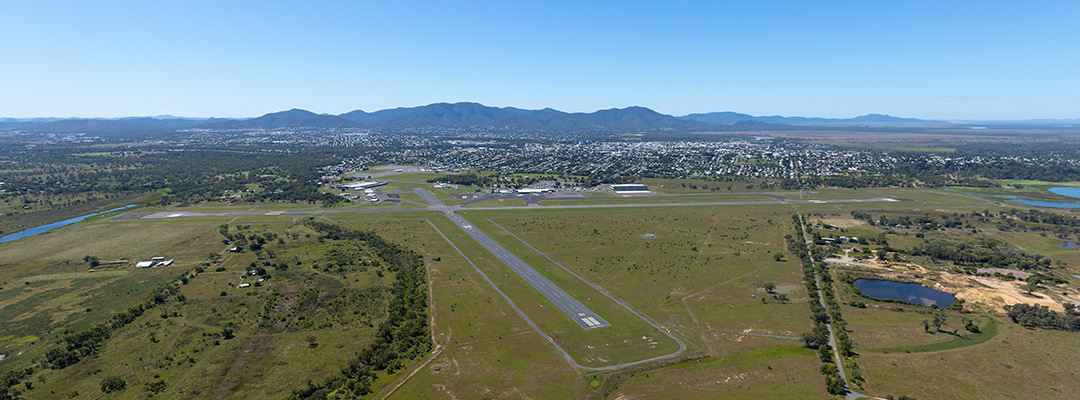 An aerial view of Rockhampton Airport and its runways, with Rockhampton and Mount Archer visible in the background