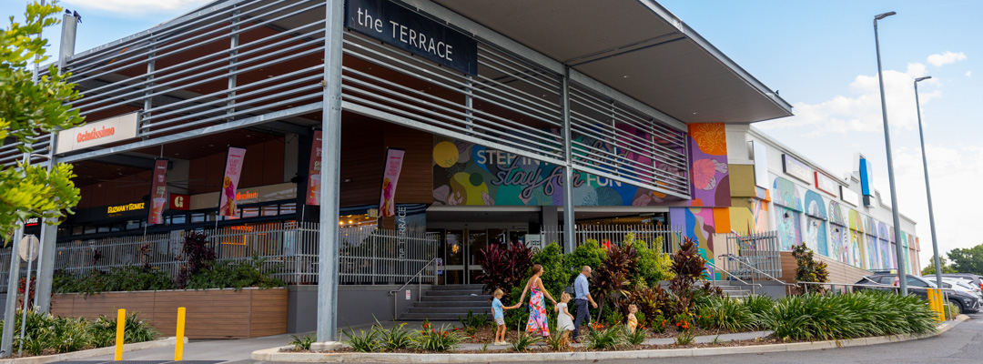 A family walks hand in hand towards the entrance of The Terrace dining precinct at Stockland Rockhampton Shopping Centre