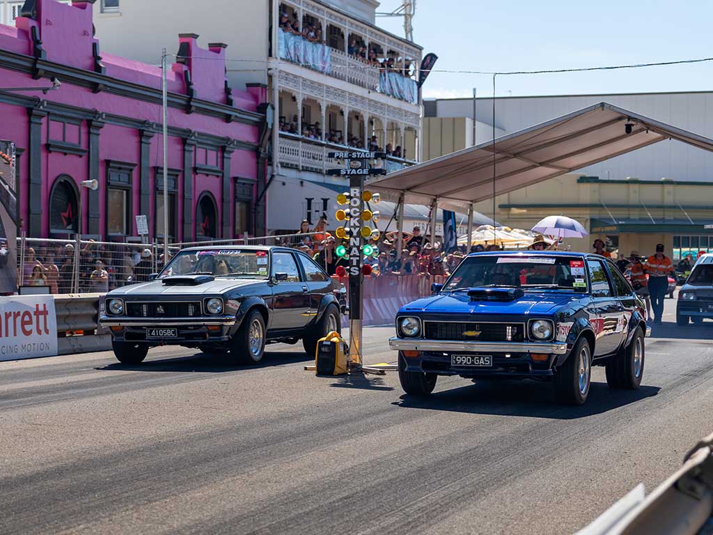 Two modified sedans start a drag race on Rockhampton's historic Quay Street